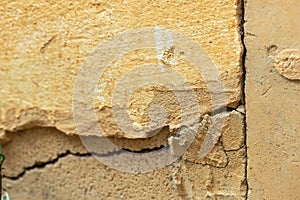 A house wall with a large crack. Grunge concrete cement wall with a crack in an industrial building