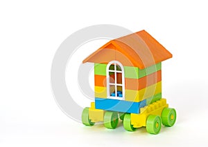 House on wheels made of plastic bricks. Isolated on white background