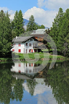 House and white lake at Crans Montana, by summer photo