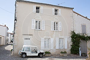 House with white shutter in old village in france