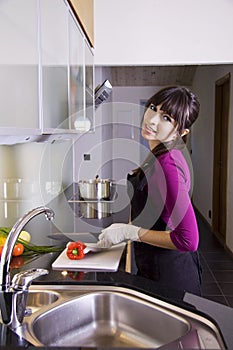 House wife slicing a red pepper