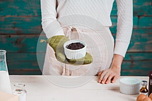 House wife wearing apron making. Steps of making cooking chocolate cake.