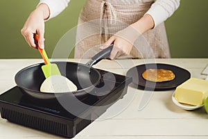 House wife wearing apron making. Steps of making cooking pancake