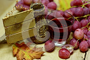 House wine wicker bottle and grapes