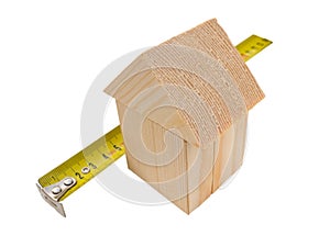 House of wooden building blocks with ruler