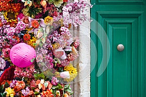 House with wooden door and colorful flowers