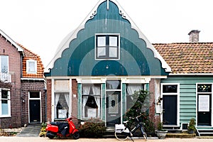 House in zaanse shans Netherlands Holland, street Hugge, bike and motorcycle parked near a historic building, beautiful rural