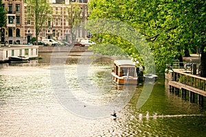 Houseboat at daytime, Amsterdam canal - Holland Netherlands