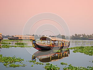 A houseboat sailing in kerala backwaters during sunset.