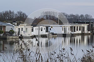 Houseboats and its reflection in the water of river Oude IJssel