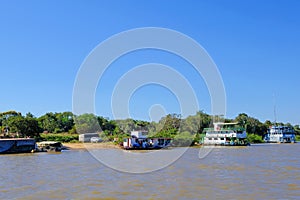 Houseboats on the riverbank at the harbor of Porto Jofre, Pantanal, Mato Grosso Do Sul, Brazil photo