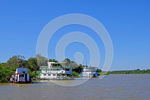 Houseboats on the riverbank at the harbor of Porto Jofre, Pantanal, Mato Grosso Do Sul, Brazil photo