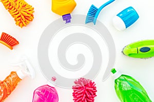 Housecleaning with detergents, soap, cleaners and brush in plastic bottles on white background top view mockup