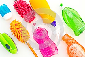 Housecleaning with detergents, soap, cleaners and brush in plastic bottles on white background top view mockup photo
