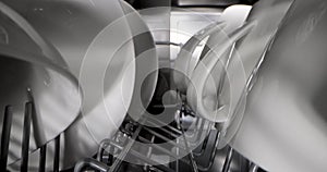 Household appliances - sliding inside dishwasher. rack with clean white dishware