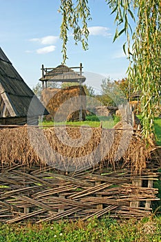 Household with braided twigs fence