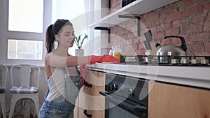 Household chores, attractive housewife woman in rubber gloves for cleaning wipe dirty furniture