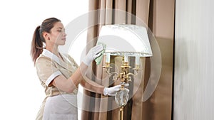 Household chores and housekeeping concept. Cleaning service in hotel. Portrait of pretty housekeeper in uniform