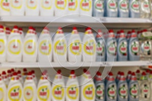 Household cleaning products on shelves in a supermarket. Big choice. Blurred