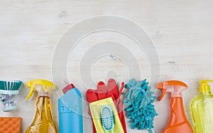 Household cleaning products on wooden background with copyspace at top