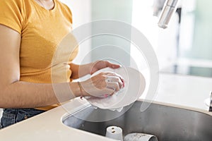 Household Duties. Unrecognizable Young Woman Washing Dishes In Kitchen At Home, Cropped