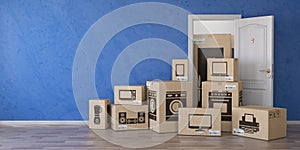 Household kitchen appliances and home electronics in cardboard b