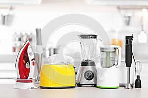 Household and kitchen appliances on table indoors