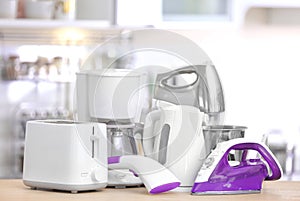 Household and kitchen appliances on table indoors