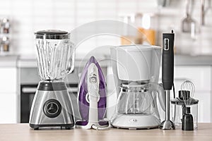 Household and kitchen appliances on table indoors