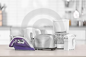 Household and kitchen appliances on table indoors