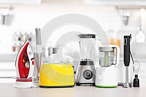 Household and kitchen appliances on table indoors photo