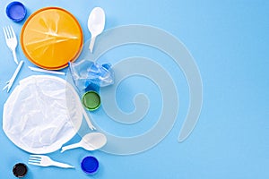 Household waste on a blue background. The concept of sorting plastic, polyethylene, cardboard, paper, glass. Environmental