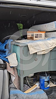 Household waste packed into a van on a rainy day