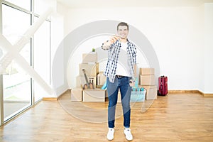 Householder Smiling While Showing Keys In New Apartment photo