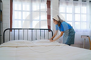 Housekeeper Making the Bed with Precision
