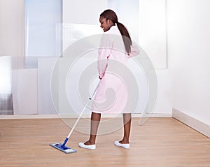 Housekeeper Mopping Floor In Hotel