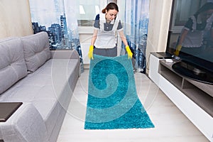 Housekeeper replacing and positioning a rug