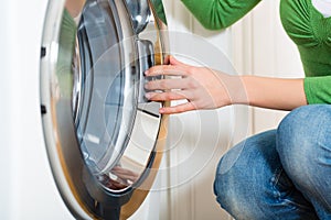 Housekeeper with washing machine photo