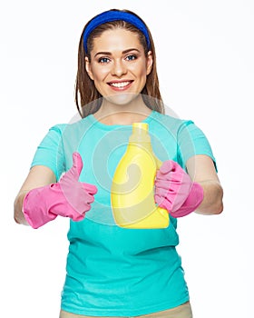 Housekeeper woman holding bottle with cleaner liquid and show t