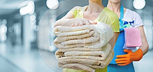 Housekeepers with cleaning supplies and linens stand