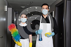 housekeepers in medical masks and rubber