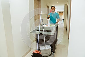 housekeepers with thumbs up pushing carts filled with cleaning supplies