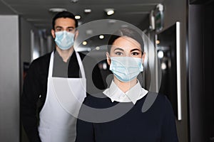 housekeepers in uniform and medical masks