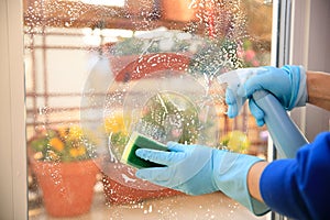 Housekeeping: cleaning the windows, Window cleaner using a squeegee, sponge and soap suds to wash a window