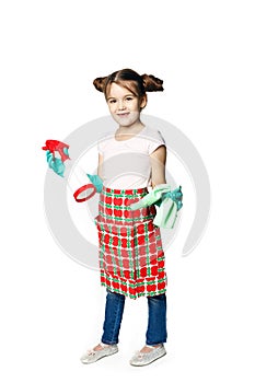 Housekeeping duties. Little girl in green rubber gloves ready for cleaning with a rag and spray for washing windows.