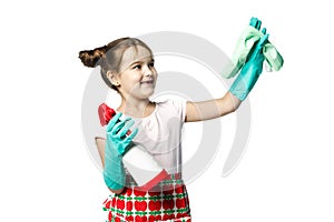 Housekeeping duties. Little girl in green rubber gloves ready for cleaning with a rag and spray for washing windows. Mom`s