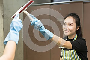 Housekeeping or maid cleaning a dirty mirror