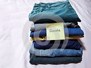 Housekeeping recycling concept. Deciding to keep, donate or discard clothing