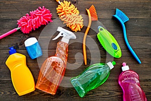 Housekeeping tool. Detergents, soap, cleaners and brush for housecleaner work on wooden background top view space for