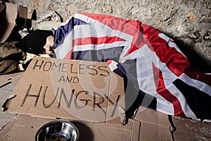 Man sleeps on street under flag of Great Britain photo